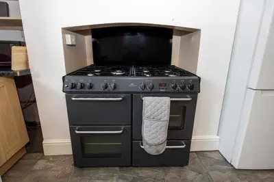 a black stove with a towel hanging on it at Cosy Two bedroom Terrace Blackburn in Cherry Tree