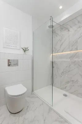 a white bathroom with a shower and a toilet at 40 Renshaw Apartments in Liverpool