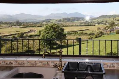 a kitchen with a sink and a window with a view at Halsteads: peaceful location, stunning views in Soutergate