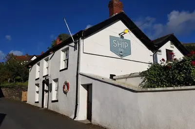 a white building with a sign on the side of it at Halsteads: peaceful location, stunning views in Soutergate