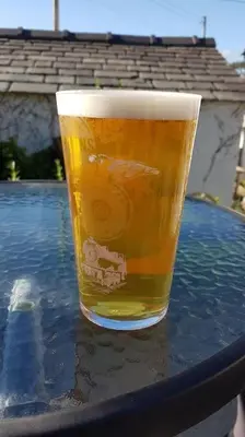 a glass of beer sitting on top of a table at Halsteads: peaceful location, stunning views in Soutergate