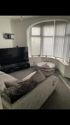 a living room with a couch and a piano at Danny holiday home in Blackpool