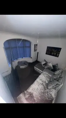 a living room with a couch and a window at Danny holiday home in Blackpool