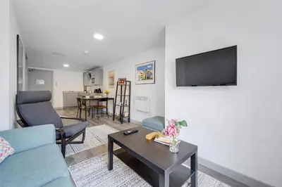 a living room with a couch and a tv on a wall at Host & Stay - The Roscoe Nest in Liverpool