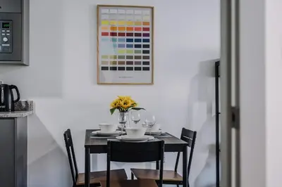 a table with glasses and a vase of flowers at Host & Stay - The Roscoe Nest in Liverpool