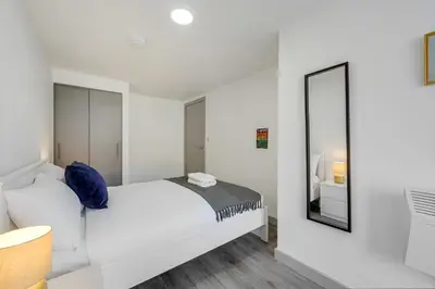 a white bedroom with a bed and a mirror at Host & Stay - The Roscoe Nest in Liverpool