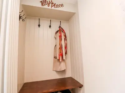 a hallway with a wooden bench in a room at Tilly's Place in Heysham