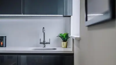 a sink in a kitchen with a plant at Host & Stay - The Baltic Penthouse 2 in Liverpool