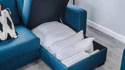 a blue couch with a white pillow on it at Host & Stay - The Baltic Penthouse 2 in Liverpool