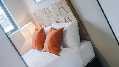 a bedroom with a bed with pillows and a headboard at Host & Stay - The Baltic Penthouse 2 in Liverpool