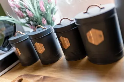 a group of four black cups sitting on a table at Charles Alexander Short Stay - Botanical House in Cleveleys