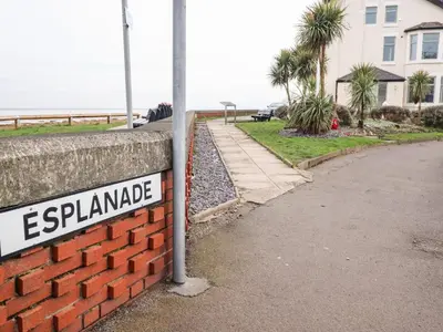 a sign on a brick wall next to a street at Ferry View in Fleetwood