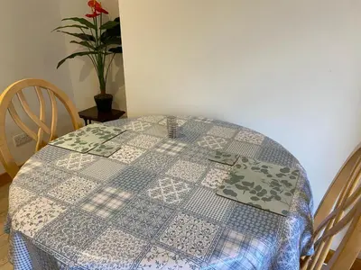 a table with a blue and white table cloth on it at The Cellar on Hornby in Morecambe