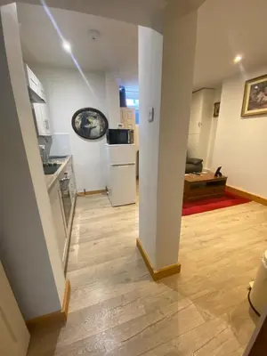 a room with a kitchen and a living room at The Cellar on Hornby in Morecambe
