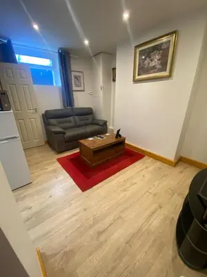 a living room with a couch and a coffee table at The Cellar on Hornby in Morecambe