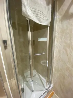 a shower with a towel on top of it at The Cellar on Hornby in Morecambe
