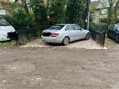 a silver car parked next to a fence at The Cellar on Hornby in Morecambe