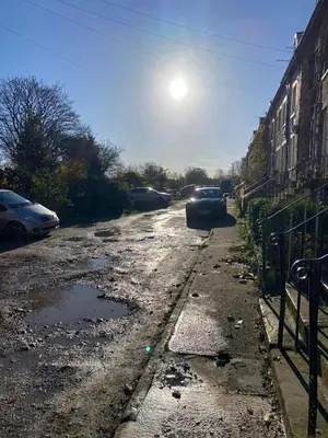 a dirty street with cars parked on it at The Cellar on Hornby in Morecambe
