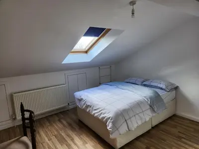 a bedroom with a bed and a skylight at Jey's Flat in Liverpool