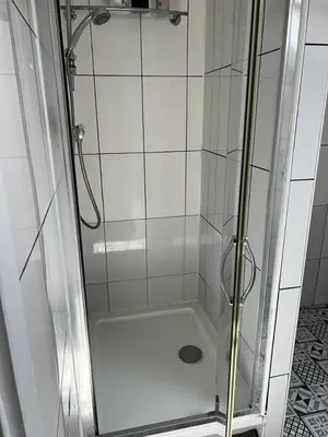 a shower with a glass door in a bathroom at Jey's Flat in Liverpool