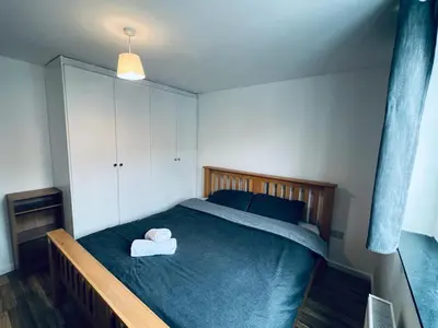 a bedroom with a bed with two towels on it at Jey's Flat in Liverpool