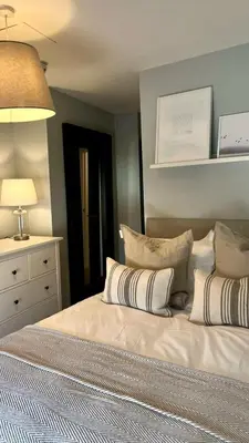 a bedroom with a bed with pillows on it at Prince Arthur Apartment in Walton on the Hill