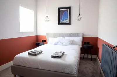 a bedroom with a bed with towels on it at Withnell Stays - Apartment Four - Ground Floor in Blackpool
