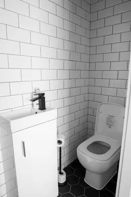 a white bathroom with a toilet and a sink at Withnell Stays - Apartment Four - Ground Floor in Blackpool