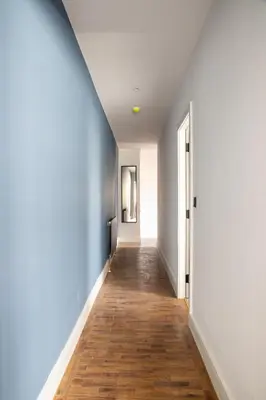 a hallway with blue walls and a wooden floor at Withnell Stays - Apartment Four - Ground Floor in Blackpool