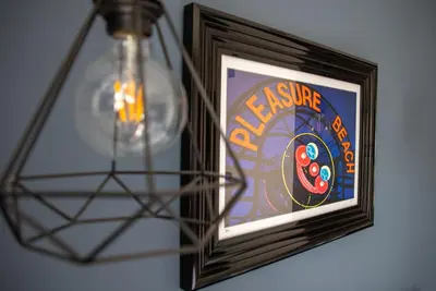 a picture in a frame on a wall with a light at Withnell Stays - Apartment Four - Ground Floor in Blackpool