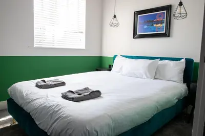 a bedroom with a bed with two towels on it at Withnell Stays - Apartment Four - Ground Floor in Blackpool