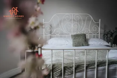a white bed with a metal headboard in a bedroom at Large City Centre Apartment - Georgian Townhouse- Rodney St in Liverpool