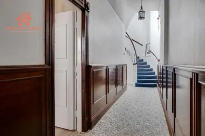 a hallway with a staircase with blue stairs in a building at Large City Centre Apartment - Georgian Townhouse- Rodney St in Liverpool