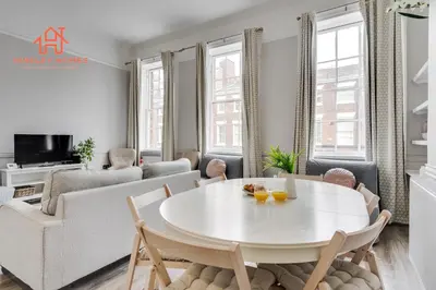 a white living room with a white table and chairs at Large City Centre Apartment - Georgian Townhouse- Rodney St in Liverpool
