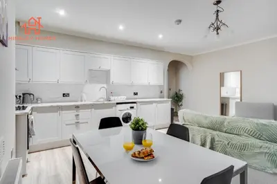 a kitchen and living room with a table with oranges on it at Large City Centre Apartment - Georgian Townhouse- Rodney St in Liverpool