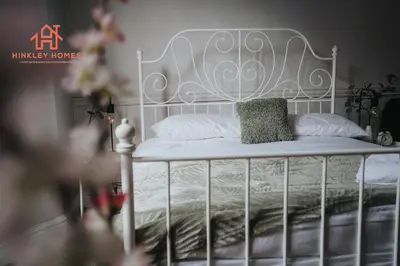 a bed with a metal frame and a pillow on it at Large City Centre Apartment - Georgian Townhouse- Rodney St in Liverpool