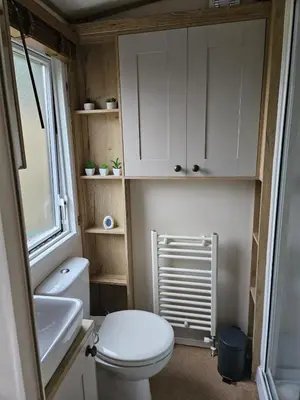 a small bathroom with a toilet and a sink at Roadnights Retreat in Heysham