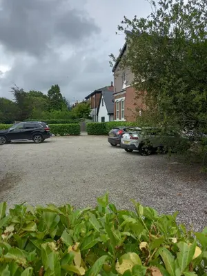a parking lot with cars parked in front of a house at Flat 4, 43 Part Street in Southport