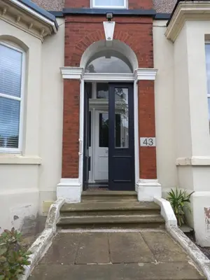 an entrance to a house with a blue door at Flat 4, 43 Part Street in Southport