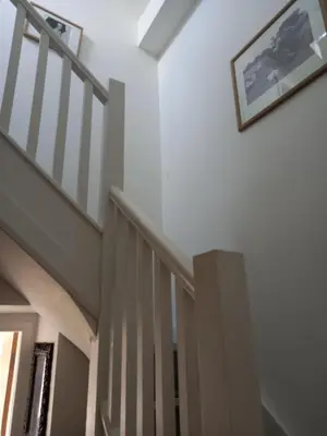 a staircase in a house with a picture on the wall at Flat 4, 43 Part Street in Southport
