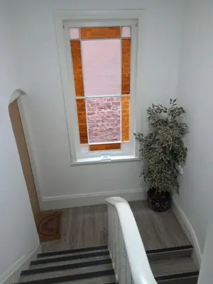 a staircase with a window and a potted plant at Flat 4, 43 Part Street in Southport