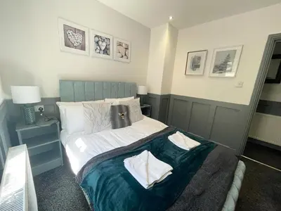 a bedroom with a large bed with two pillows on it at Olivia Rose Suite by Sasco Apartments in Blackpool