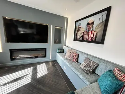 a living room with a flat screen tv and a couch at Olivia Rose Suite by Sasco Apartments in Blackpool