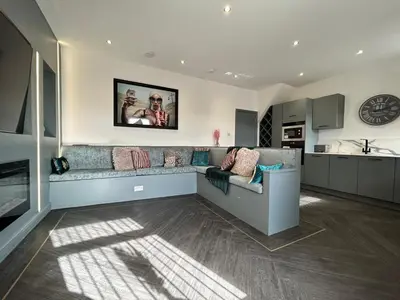 a living room with a couch and a kitchen at Olivia Rose Suite by Sasco Apartments in Blackpool