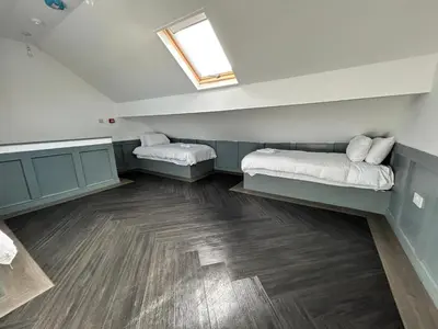 a room with two beds and a window at Olivia Rose Suite by Sasco Apartments in Blackpool