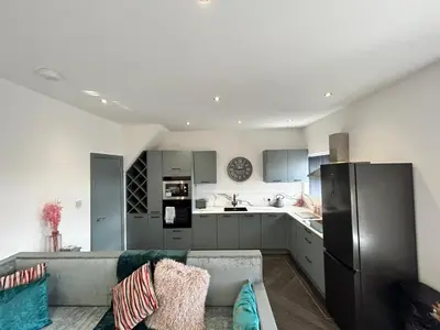 a living room with a couch and a kitchen at Olivia Rose Suite by Sasco Apartments in Blackpool