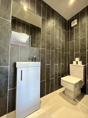a bathroom with a toilet and a mirror at Olivia Rose Suite by Sasco Apartments in Blackpool