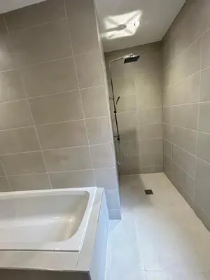 a bathroom with a bath tub and a shower at Olivia Rose Suite by Sasco Apartments in Blackpool