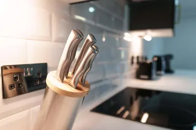 a wooden knife holder on a kitchen counter at Lovely 1 Bedroom Apartment in Preston in Preston