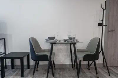 a dining room table with chairs and wine glasses at Lovely 1 Bedroom Apartment in Preston in Preston